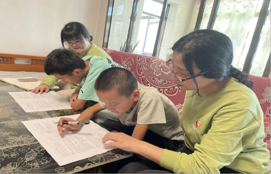 图实践团指导老师江雪茹、钱雪蕾指导二连村的同学填写调查问卷